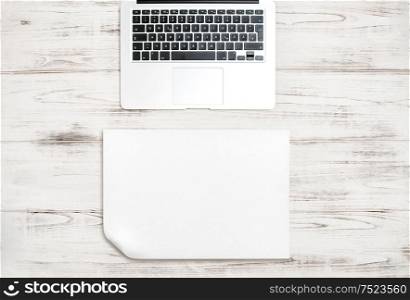 Keyboard over wooden desk. Paper background for Your text or picture. Office workspace