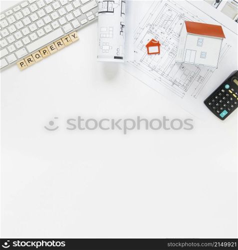 keyboard with house model blueprint real estate office desk