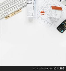 keyboard with house model blueprint real estate office desk