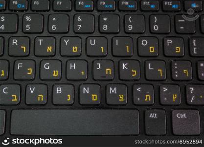 Keyboard with letters in Hebrew and English - Laptop keyboard - Top View - Close up