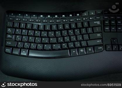 Keyboard with letters in Hebrew and English - Wireless keyboard - Top View - Dark atmosphere