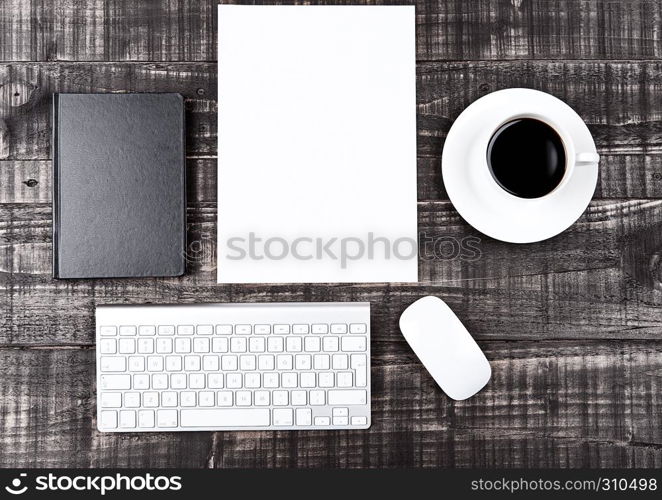 Keyboard with phone paper sheet and coffee cup on office desk