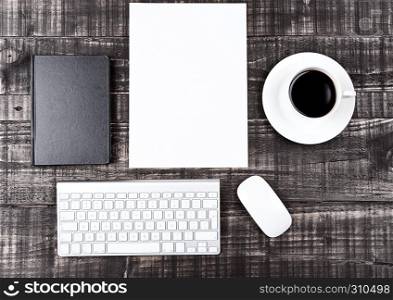 Keyboard with phone paper sheet and coffee cup on office desk