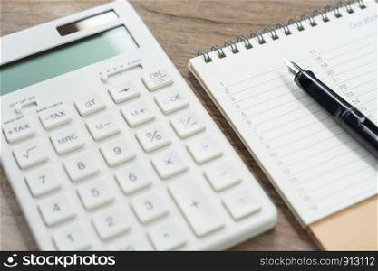 Keypad TAX button For tax calculation. Easy to calculate. on White calculator wood background using as background business concept and Education concept with copy spaces for your text or design.