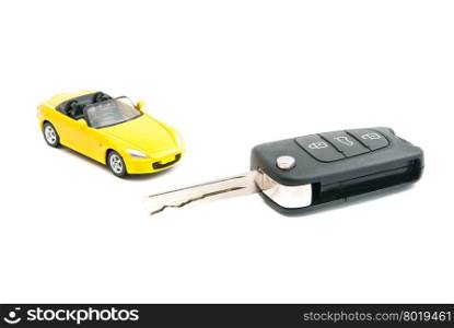 keys and yellow car closeup on white background