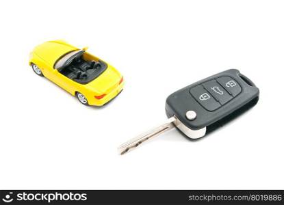keys and yellow sport car closeup on white