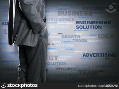 Keywords of business. Bottom view of businessman with hands in pockets