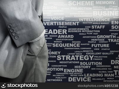 Keywords of business. Bottom view of businessman with hands in pockets