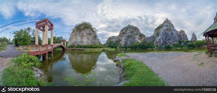 Khao Ngu Stone. National park with reflection of river lake, mountain valley hills, and tropical green forest trees at sunset in Ratchaburi, Thailand in travel trip. Natural landscape background.
