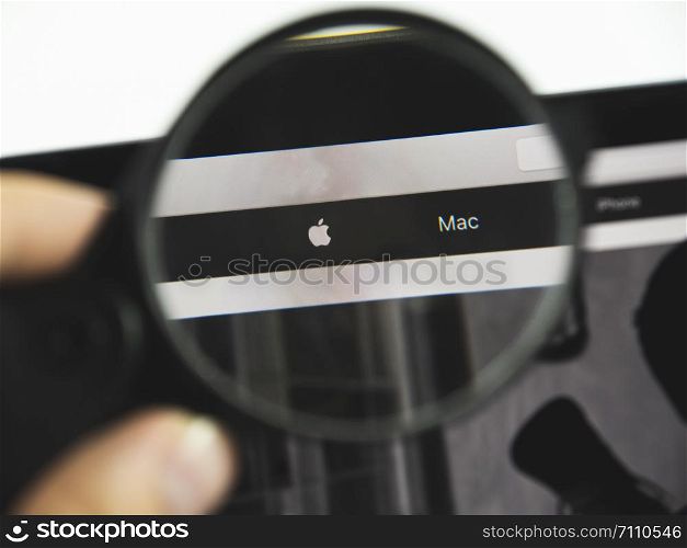 Kharkov city / Ukraine - August 2019: Apple logo on a web page. View of the monitor screen through a magnifying glass