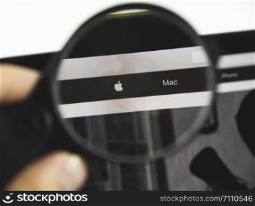Kharkov city / Ukraine - August 2019: Apple logo on a web page. View of the monitor screen through a magnifying glass