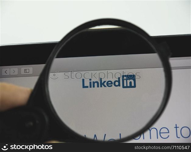 Kharkov city / Ukraine - August 2019: LinkedIn logo on a web page. View of the monitor screen through a magnifying glass