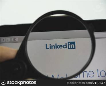 Kharkov city / Ukraine - August 2019: LinkedIn logo on a web page. View of the monitor screen through a magnifying glass