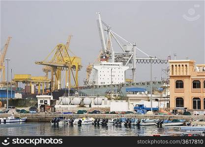 Khor Fakkan, UAE, Large cargo ships docked to load and unload goods at Khor Fakkport
