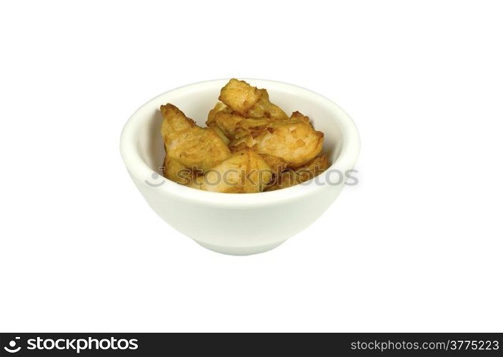Kibbeling baked in a bowl on a white background.