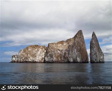 Kicker Rock, or Leon Dormido, is a desolate, barren rock off San Cristobal Island in the Galapagos that is a favored spot for snorkeling and scuba diving.