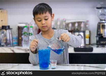 kid boy making mix water blue hawaii