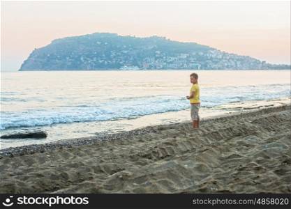 Kid boy walking at Alania beach, Turkey