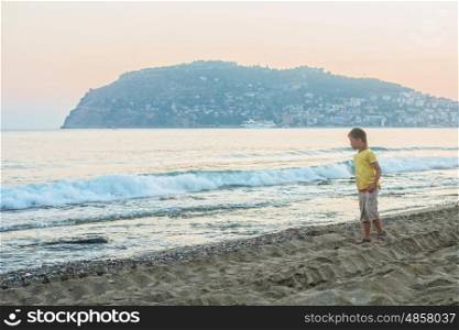 Kid boy walking at Alania beach, Turkey
