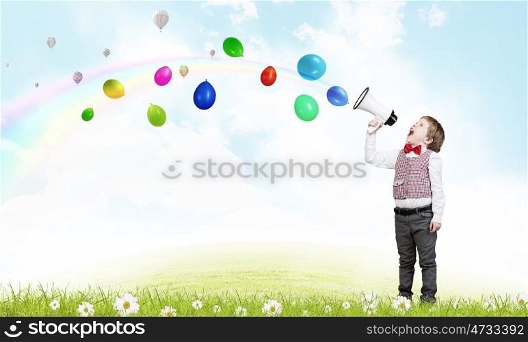 Kid boy with megaphone. Little sweet boy screaming emotionally into megaphone