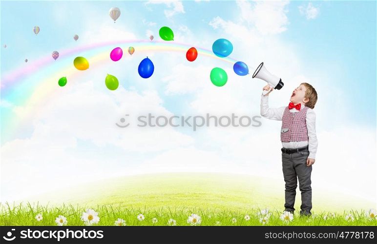 Kid boy with megaphone. Little sweet boy screaming emotionally into megaphone