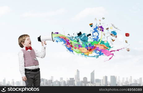 Kid boy with megaphone. Little sweet boy screaming emotionally into megaphone