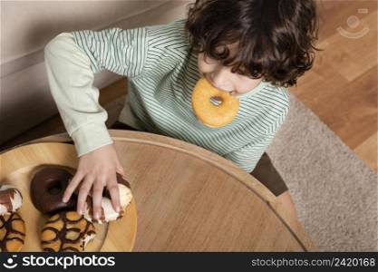 kid eating doughnuts home