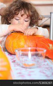 kid emptying a pumpkin