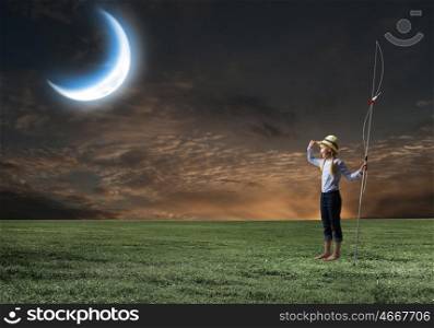Kid fisherman. Cute girl at night with fishing rod looking far away