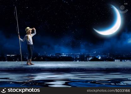 Kid fisherman. Cute girl at night with fishing rod looking far away