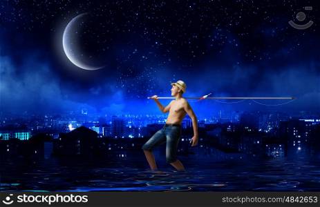 Kid fisherman. Young boy at night with fishing rod