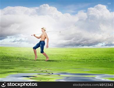 Kid fisherman. Young boy walking with fishing rod on shoulder