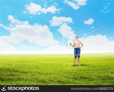 Kid fisherman. Young boy with fishing rod on shoulder