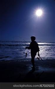 kid fishing at the beach