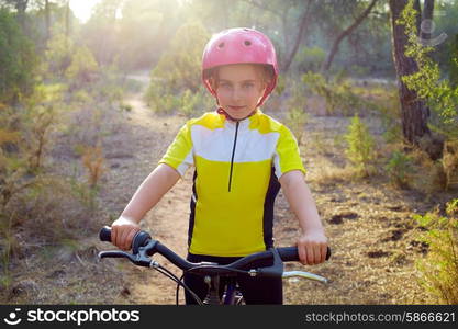 kid girl biker in mountain bike MTB at mediterranean forest