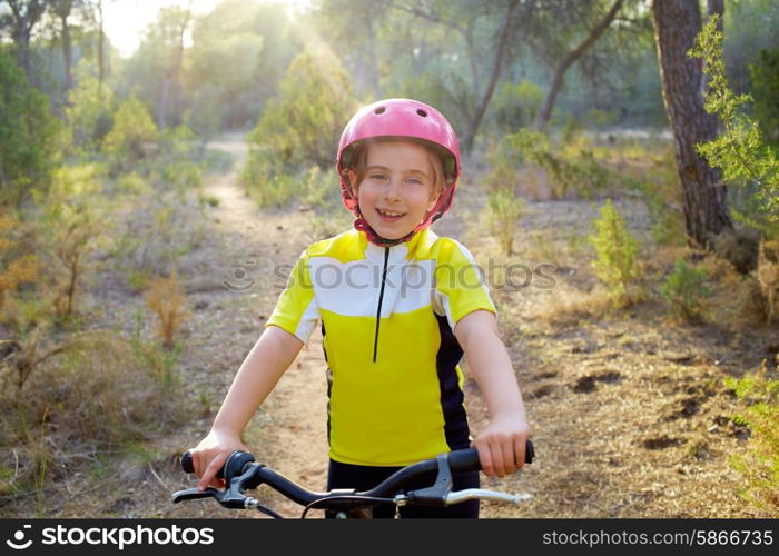 kid girl biker in mountain bike MTB at mediterranean forest