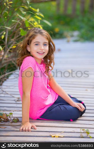 Kid girl in autumn deck smiling with braces teeth apparatus outdoor