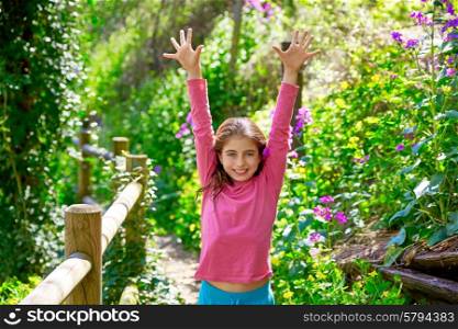 kid girl in spring track in Cuenca forest of Spain with wooden fence