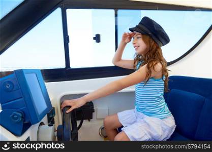 Kid girl pretending be a captain sailor cap in boat indoor holding wheel