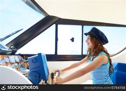 Kid girl pretending be a captain sailor cap in boat indoor holding wheel