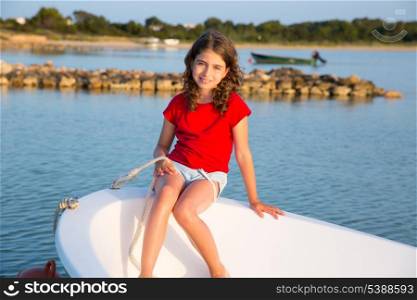 Kid girl pretending to be a sailor in boat bow at Formentera Balearic Islands
