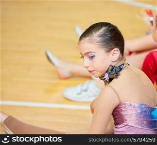 kid girl rhythmic gymnastics on wooden deck profile