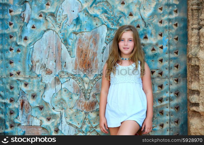 Kid girl tourist in Mediterranean old town door at Spain