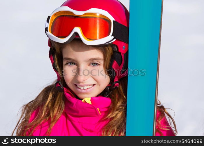 Kid girl winter snow portrait with ski equipment helmet and goggles