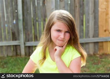 kid girl with disappoint expression finger thinking expression outdoor