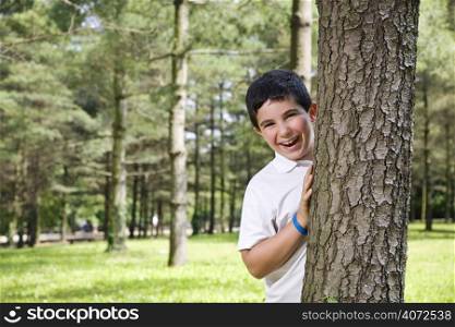 Kid hidding behind a tree