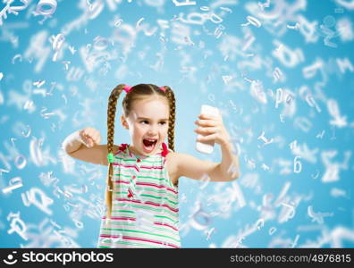 Kid in anger. Image of little angry girl shouting in mobile phone
