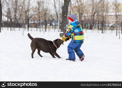 Kid of school age with dog in winter park. My best friend and I