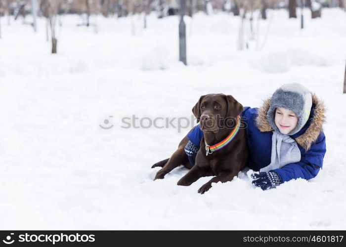 Kid of school age with dog in winter park. My best friend and I