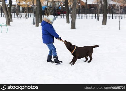 Kid of school age with dog in winter park. My best friend and I